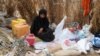 FILE - A Yemeni woman sits in the remains of a home in a neighborhood ravaged by Tropical Cyclone Sagar, in the port city of Hodeidah, Yemen, May 19, 2018