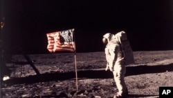In this image provided by NASA, astronaut Buzz Aldrin poses for a photograph beside the U.S. flag deployed on the moon during the Apollo 11 mission on July 20, 1969. (Neil A. Armstrong/NASA via AP, File)