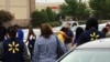 imagen provista por WREG-TV, muestra a empleados de Walmart en un círculo de oración afuera de la tienda, el martes 30 de julio de 2019, en Southaven, Mississippi, luego de un tiroteo. (Jerrita Patterson/WREG-TV via AP).