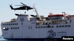 Members of the special forces abseil from a UH-60A Black Hawk helicopter as others use a rope ladder to board a ship during a boarding drill, part of the Eager Lion military exercise, in the coastal city of Aqaba, June 19, 2013.