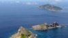 A group of disputed islands, Uotsuri island (top), Minamikojima (bottom) and Kitakojima, known as Senkaku in Japan and Diaoyu in China is seen in the East China Sea, in this photo taken by Kyodo September 2012. 