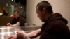 FILE - Richard Chenery injects heroin he bought on the street at the Insite safe injection clinic in Vancouver, B.C., Canada.