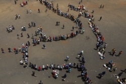 Mourners arrive at Rufaro stadium, in Mbare township where the body of Zimbabwe's founder Robert Mugabe will lie in state, Harare, Sept. 12, 2019.