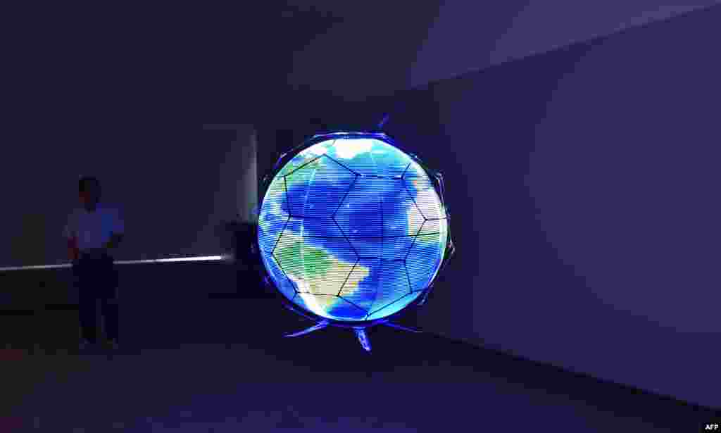 Japan's NTT DOCOMO demonstrates a spherical drone, an unmanned aerial vehicle that displays LED images on an omnidirectional spherical screen while in flight, at the company's research laboratories in Yokosuka, Kanagawa prefecture.