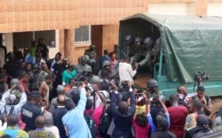 FILE - School children, who were kidnapped by armed men and released, are helped to get into a truck by gendarmes in Bamenda, Cameroon, Nov. 7, 2018.