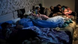 In this handout photo released by the Armenian Foreign Ministry on Monday, Sept. 28, 2020, people watch the State TV as they gather in a bomb shelter to protect against the shelling in Stepanakert, the self-proclaimed Republic of Nagorno-Karabakh,…