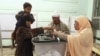 People cast their votes during the final stage of a referendum on Egypt's new constitution in Bani Sweif, about 115 km (71 miles) south of Cairo December 22.