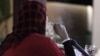 A Palestinian woman smokes a water pipe at a cafe in Gaza City, July 2010.