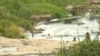 Children bath and swim in a river as people turn to unprotected sources of water in Harare, Zimbabwe, March 7, 2019. 