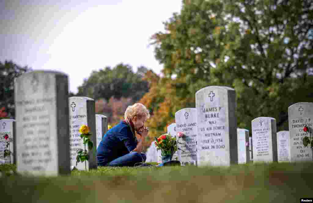 Mary Jane McWilliams from Fredrick, Maryland, visits her son's grave on Veterans Day, at Arlington National Cemetery in Washington.