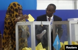 FILE - A Somali lawmaker casts her ballot during the presidential vote at the airport in Somalia's capital Mogadishu, Feb. 8, 2017.