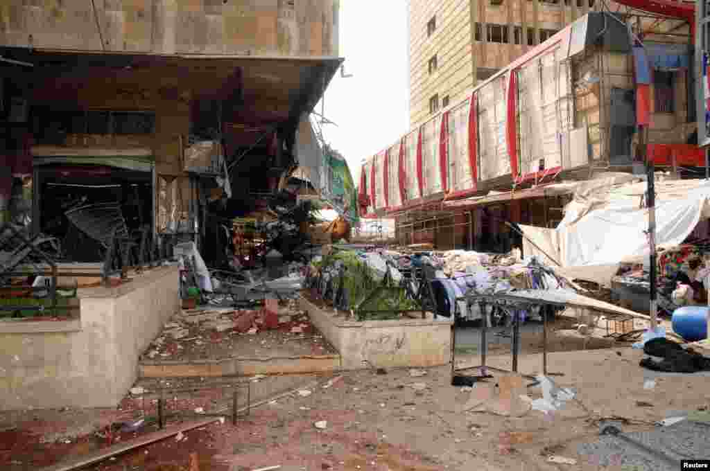 Debris and damaged buildings are seen after blasts in Aleppo, Syria, October 3, 2012.
