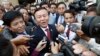 Cambodia's main opposition Cambodia National Rescue Party Deputy President, center, speaks to reporters outside the Phnom Penh Municipality Court in Phnom Penh, Cambodia, Wednesday, April 8, 2015. 