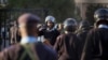 FILE - Riot police are ordered inside the Parliament building itself as chaos between MPs erupts inside, in Nairobi, Kenya, Dec. 18, 2014.
