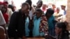 Burundian refugees, register with officials at a Bugesera reception center Eastern Rwanda. (Mohammed Yusuf for VOA)