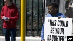 A group of protesters stands outside the South African Parliament on September 21, 2011 in Cape Town, demonstrating against human trafficking.