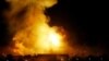 Government buildings burn during U.S.-led "shock and awe" bombardment of Baghdad, March 21, 2003.