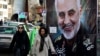 Women walk past a banner of Iranian Revolutionary Guard Corps Gen. Qassem Soleimani, who was killed in Iraq in a U.S. drone attack Friday, in Tajrish Square in northern Tehran, Iran, Jan. 9, 2020.