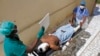 Medical workers attend to a man injured in a mortar shell attack, at Medina hospital during Somali Independence day ceremony in Mogadishu, Somalia, July 1, 2018. 