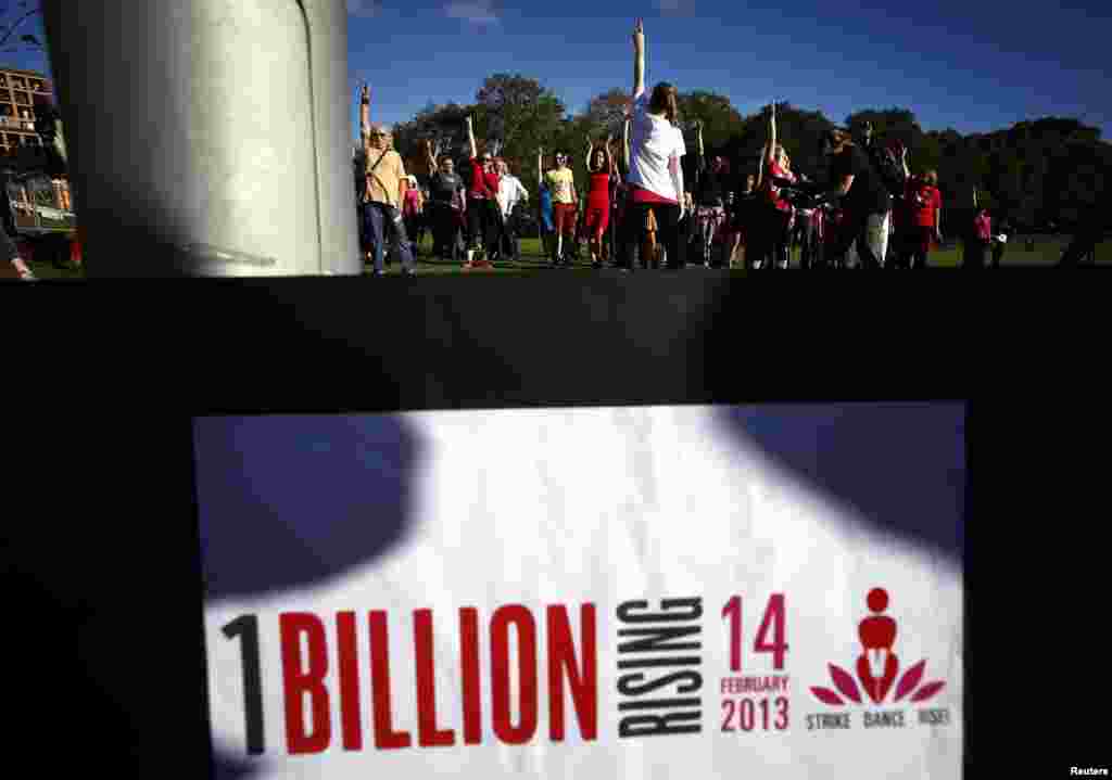 A group of women and men dance as they participate in an event labelled 'One Billion Rising' at a park in central Sydney, Australia, Feb. 14, 2013.