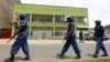 FILE - Riot policemen are seen walking outside the Radio Publique Africaine broadcasting studio in Burundi's capital, Bujumbura, Apr. 26, 2015. 