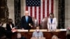US Vice President Mike Pence (C) arrives to preside over a joint session of Congress counting the electoral votes for President after they resumed the session following protests at the US Capitol in Washington, DC, January 7, 2021. - US lawmakers formally