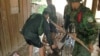 An unidentified injured soldier (uncertain who he belongs to) is helped in a make-shift stretcher by his comrades after a tank he was riding was hit by a rocket Sunday, July 6, 1997, a fighting between Hun Sen and Prince Ranarridh's armie near Phnom Penh's university on the outskirts of the capital. Hun Sen claimed the current fighting a coup attempt by Prince Ranarridh as thousands of inhabitants try to escape from the capitol. (AP Photo/Masaru Goto)
