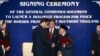 Secretary-General of Thailand's National Security Council, Paradorn Pattanathabutr, center left, shakes hands with chief of Thailand's National Revolution Front (BRN) liaison office in Malaysia, Hassan Taib, center right, Kuala Lumpur, Feb. 28, 2013.