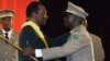 Mali's Interim President Dioncounda Traore, left, is congratulated by coup leader Amadou Sanogo after being sworn in at a ceremony in Bamako, Mali, April 12, 2012. 