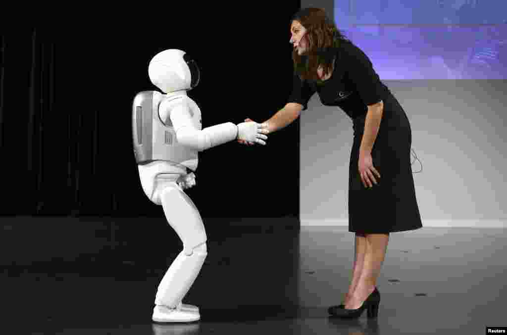 Honda's latest version of the Asimo humanoid robot shakes hands during a presentation in Zaventem near Brussels, Belgium. Honda introduced an improved version of its Asimo humanoid robot that it says has enhanced intelligence and hand dexterity, and is able to run at a speed of some 9 kilometers per hour (5.6 miles per hour).