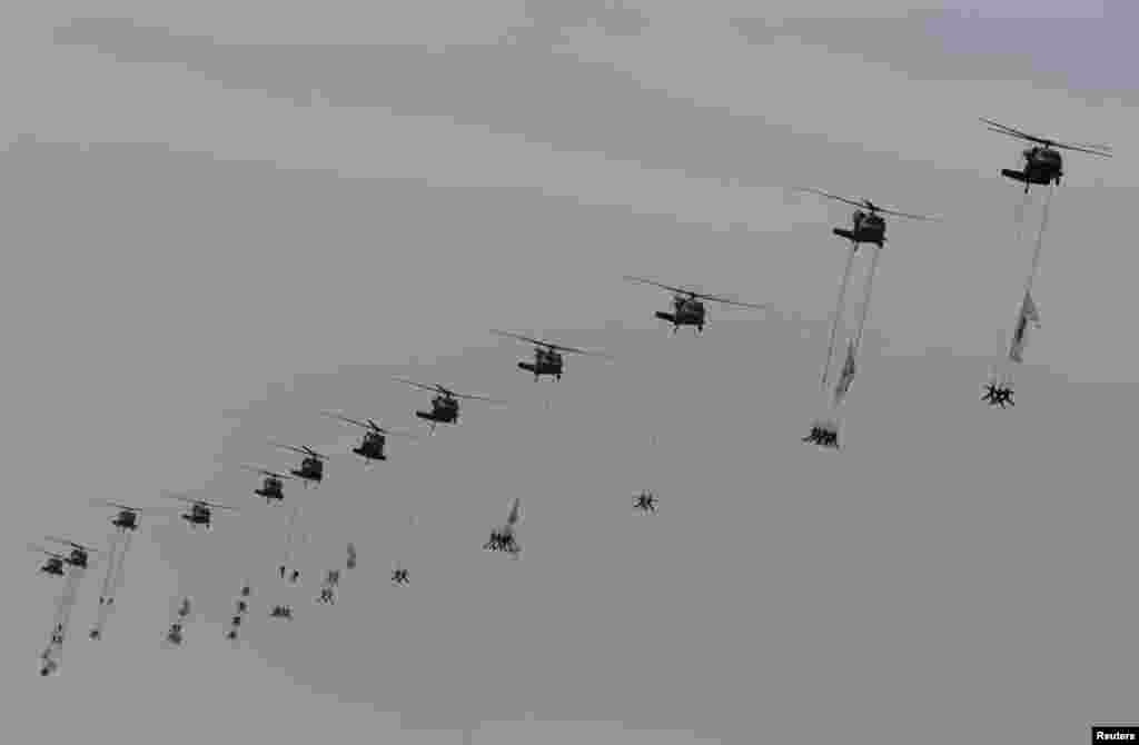 Members of the Special Warfare Command are suspended from army helicopters during a celebration marking the 65th anniversary of Korea Armed Forces Day, Seongnam, Seoul, Oct. 1, 2013.