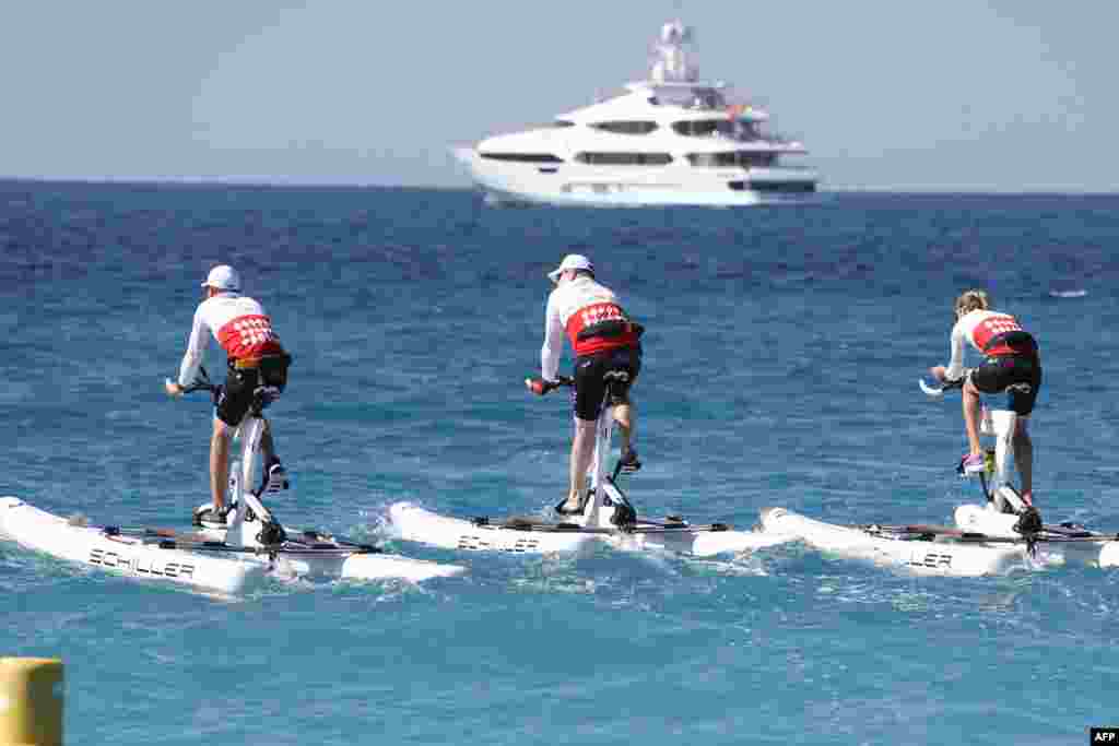 Prince Albert II of Monaco (C) competes in the first "Riviera water bike challenge", a cycling race between Nice and Monaco, in Nice, southeastern France.
