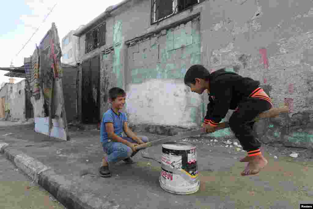 Palestinian children play outside their house at a refugee camp in Gaza City, Gaza Strip.