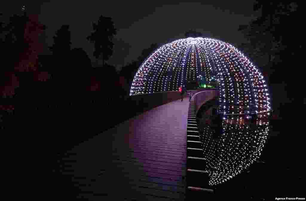 Lights illuminate the Sackler Crossing during a photocall at Kew Gardens in south west London, to preview the "Christmas at Kew" light show event.