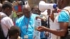 FILE - UNICEF health workers teach people about the Ebola virus and how to prevent infection, in Conakry, Guinea, March 31, 2014..
