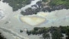 In this March 24, 2011 file photo, oil is seen on the creek's surface near an illegal oil refinery in Ogoniland, outside Port Harcourt, in Nigeria's Delta region (AP).
