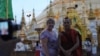A western tourist poses for a photograph with a Buddhist monk at the Shwedagon Pagoda in Rangoon, Burma, May 31, 2012.