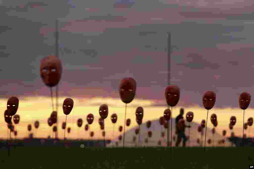 Masks representing corrupt politicians line the lawn outside the National Congress building in Brasilia. Brazil's Supreme Court has opened investigations into President Michel Temer for allegedly obstructing justice, passive corruption and being a member of a criminal organization. The move follows release of an audiotape that appears to show him endorsing the payment of hush money to an imprisoned former ally in exchange for silence.