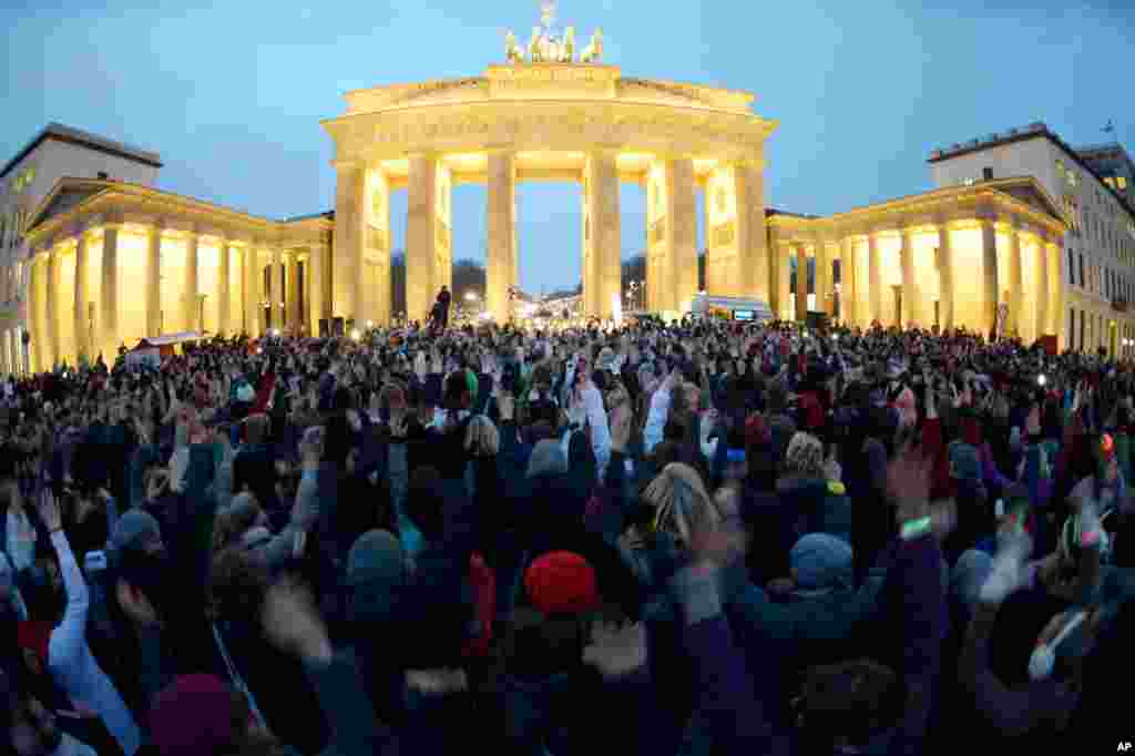 Participants gather in front of the Brandenburg Gate and dance for the 'One Billion Rising' movement, Berlin, Germany, Feb. 14, 2013.