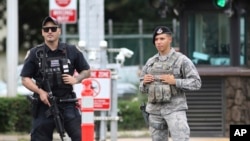 Security stands guard outside the main gate at Joint Base Pearl Harbor-Hickam, in Hawaii, Dec. 4, 2019.