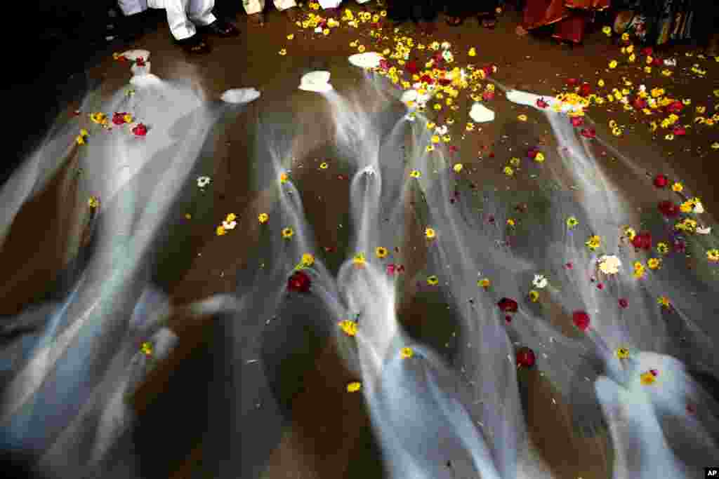 Indians offer milk during a prayer ceremony to commemorate the 9th anniversary of the 2004 Tsunami, on Marina beach, in Chennai. The Tsunami triggered by a 9.1 magnitude earthquake on Dec. 26, 2004 killed tens of thousands in 12 Indian Ocean nations.