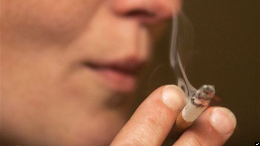 FILE - A person smoking a cigarette.