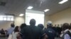 People watch results during a test of the Results Management System as votes trickled in from various constituency centers, at the main tallying center in Blantyre, Malawi.