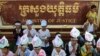 Children of women who were arrested in clashes with police during forced evictions at Boeung Kak lake, wear portraits of their mothers around their foreheads as they pray at a protest in front of the Ministry of Justice in the capital of Phnom Penh, file photo. 