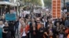 In this image made from video provided by AUBC, people march and shout slogans during a protest against gender-based violence, in Melbourne, Australia, April 28, 2024. Officials met in Canberra Wednesday to discuss ways to address the issue.