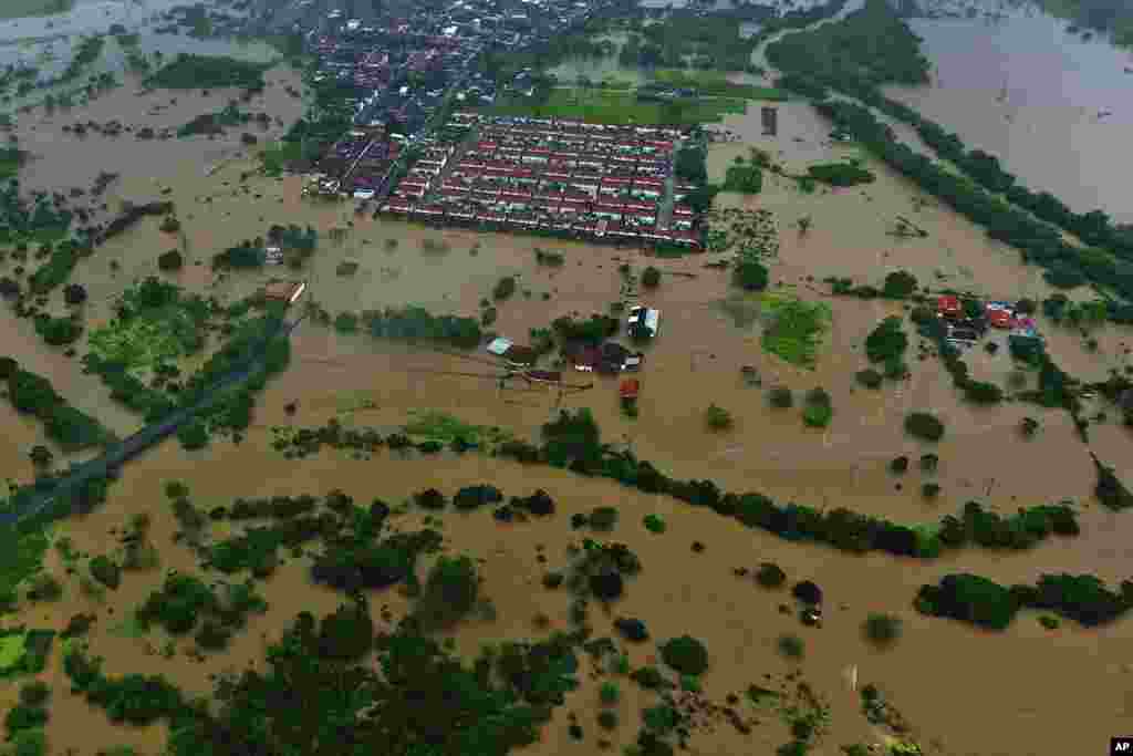 Flood waters submerge the city of Itapetinga in the southern region of the state of Bahia, Brazil, Dec. 26, 2021. The Bahia state government's press office said heavy rains have caused floods that have killed 18 people and affected more than 30 cities since early November, forcing more than 4,000 from their homes and complicating access to some communities.