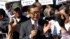 Opposition leader of Cambodia National Rescue Party Sam Rainsy, center, delivers a speech during a gathering to mark Human Rights Day, in front of National Assembly, in Phnom Penh, Cambodia, file photo. (AP Photo/Heng Sinith)