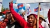 Cambodian garment workers shout slogans during a gathering to mark May Day celebrations in Phnom Penh, Cambodia, Friday, May 1, 2015. Garment workers staged a rally to demand higher wage and better working condition. The placard at right in the background reads: "Demanding the government urgently set up the labor court." (AP Photo/Heng Sinith)