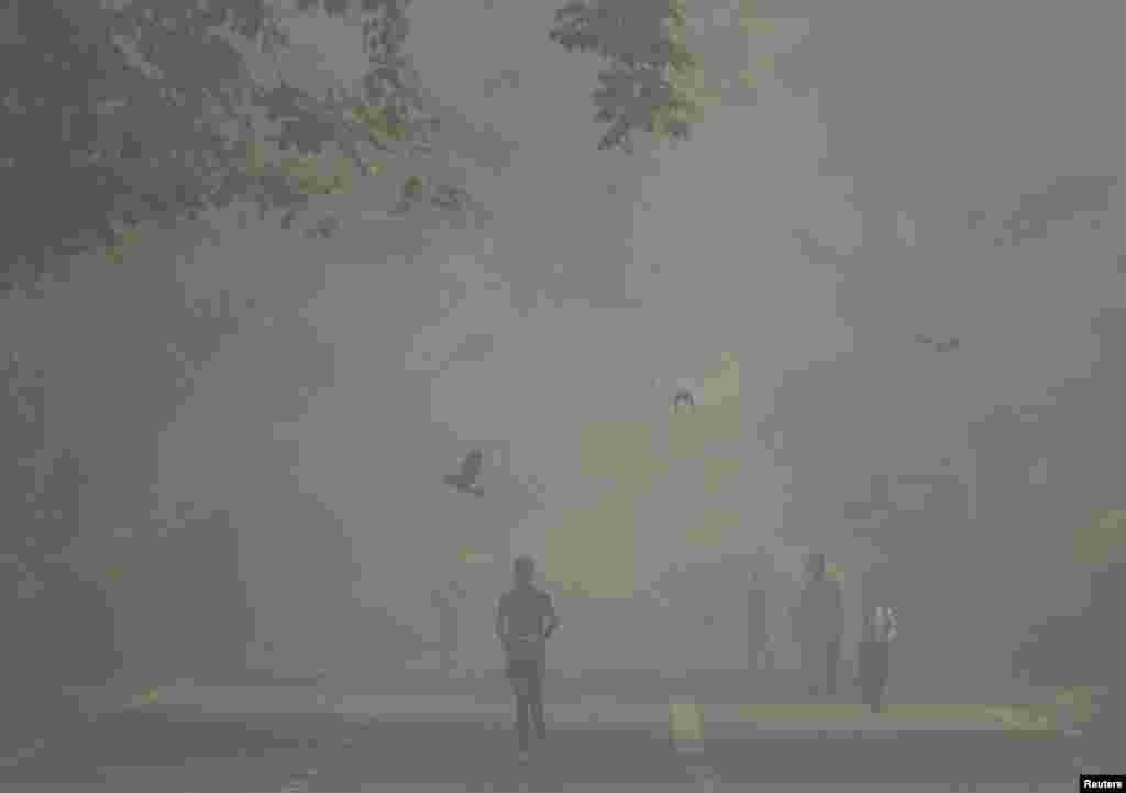 A man jogs as he participates in a marathon while the sky is enveloped with smog after Delhi’s air quality was classified as "hazardous" amidst severe air pollution, in New Delhi, India.