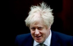 FILE - Britain's Prime Minister Boris Johnson leaves Downing Street for the State Opening of Parliament by Queen Elizabeth II, in the House of Lords at the Palace of Westminster in London, Dec. 19, 2019.